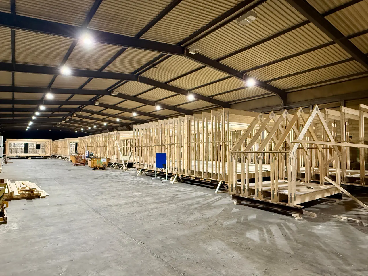 Mountfield airspace scheme under construction with long wall frames and separate gable trusses lined up on the factory floor